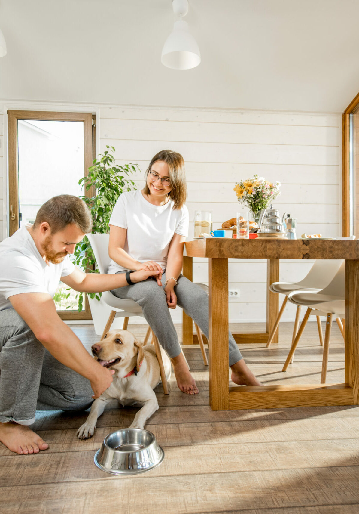 Young couple with dog at home | Floor to Ceiling Hayward